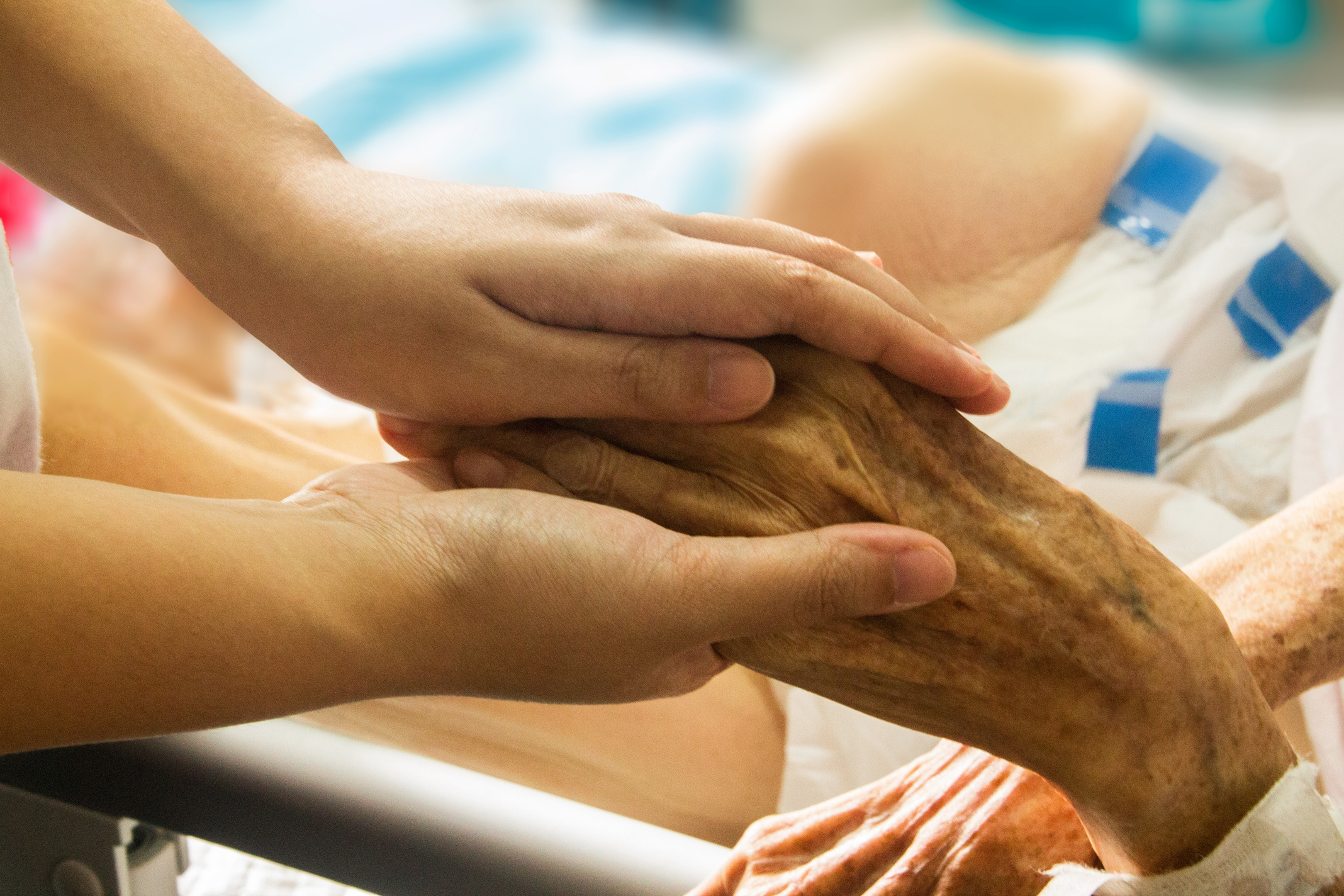 Person Holding the Hand of a Hospice Patient